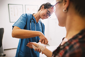 A caregiver helping a resident with wound care bandages