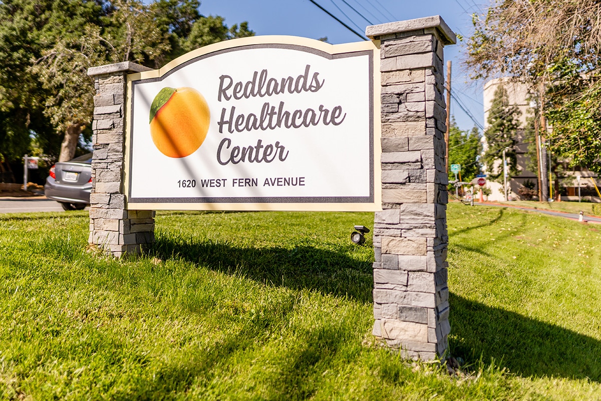 The welcome sign to Redlands Healthcare Center