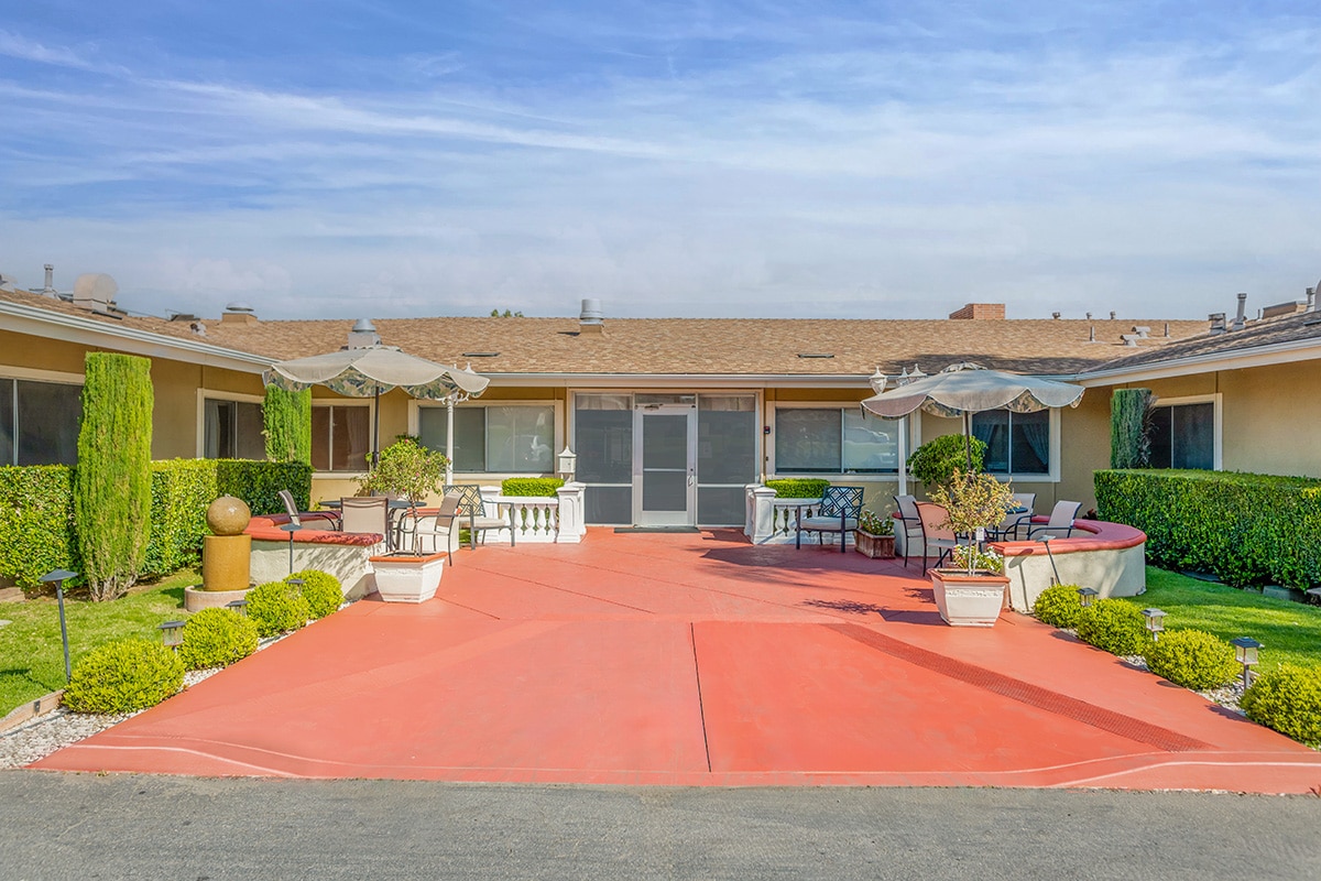 A porch with plants and umbrellas at Redwood Healthcare Center