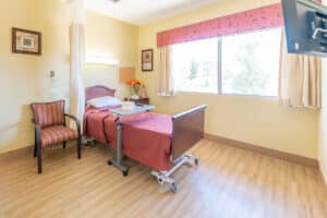 A patients bed and window at Redlands Healthcare Center