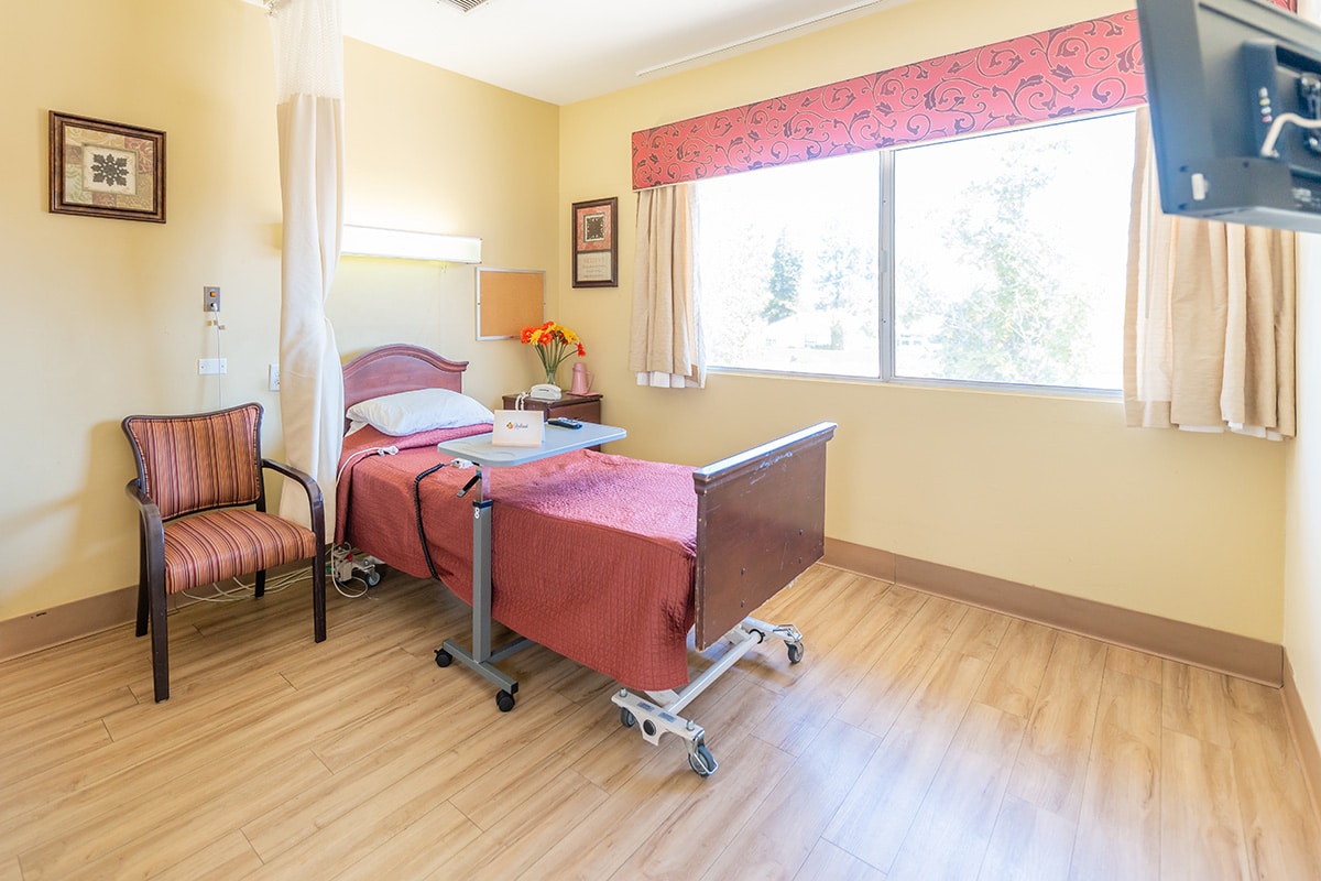A patients bed and window at Redlands Healthcare Center