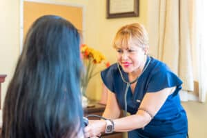 A nurse helping a patient at Redlands Healthcare Center