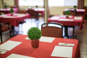 A dining table with a plant at Redlands Healthcare Center