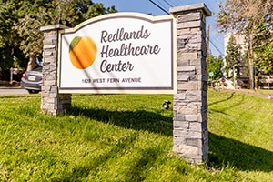 The monument sign out front the Redlands Healthcare facility