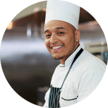 smiling chef wearing a chef hat