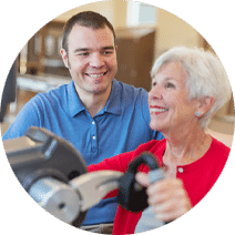 elderly woman doing an arm exercise with a rehab nurse